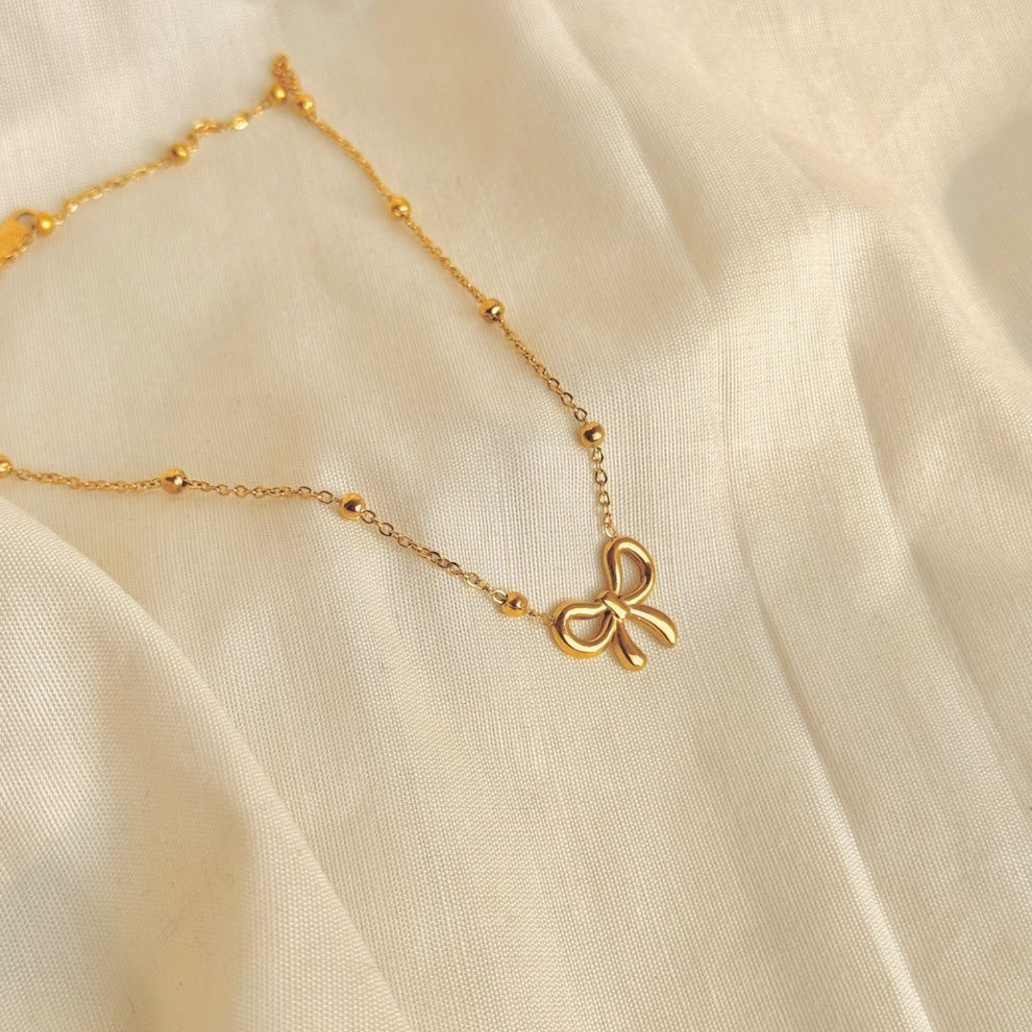 Trendy Hollow 18k Gold Plated Stainless Steel Bow Necklace with Beaded Chain